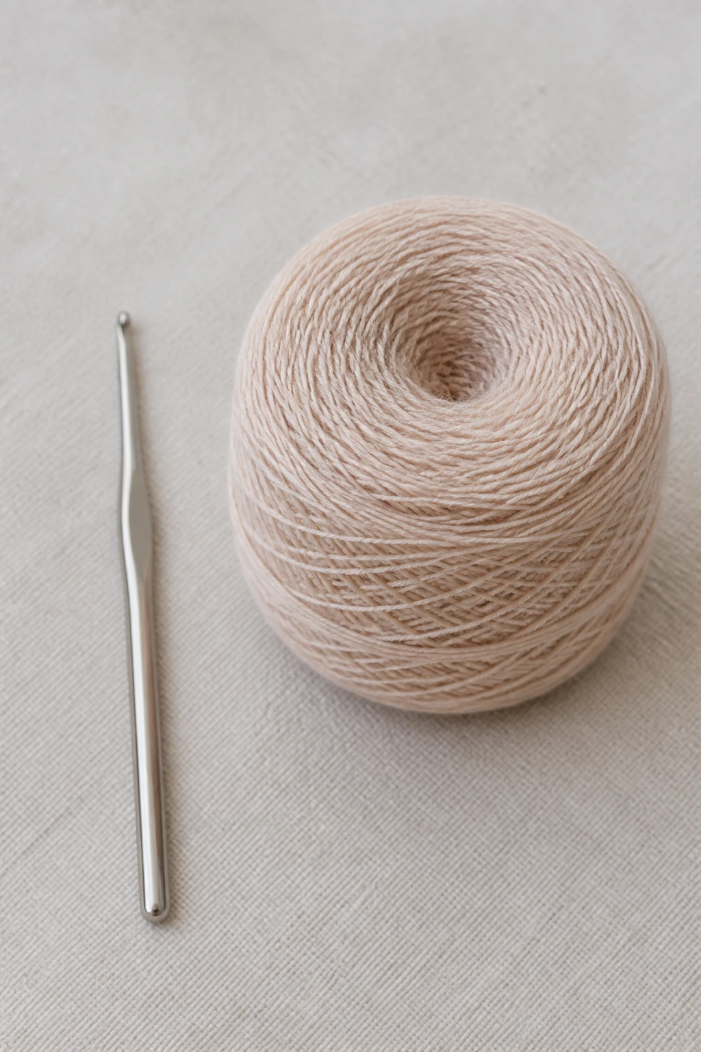 0 mm crochet hook beside fine yarn wound neatly