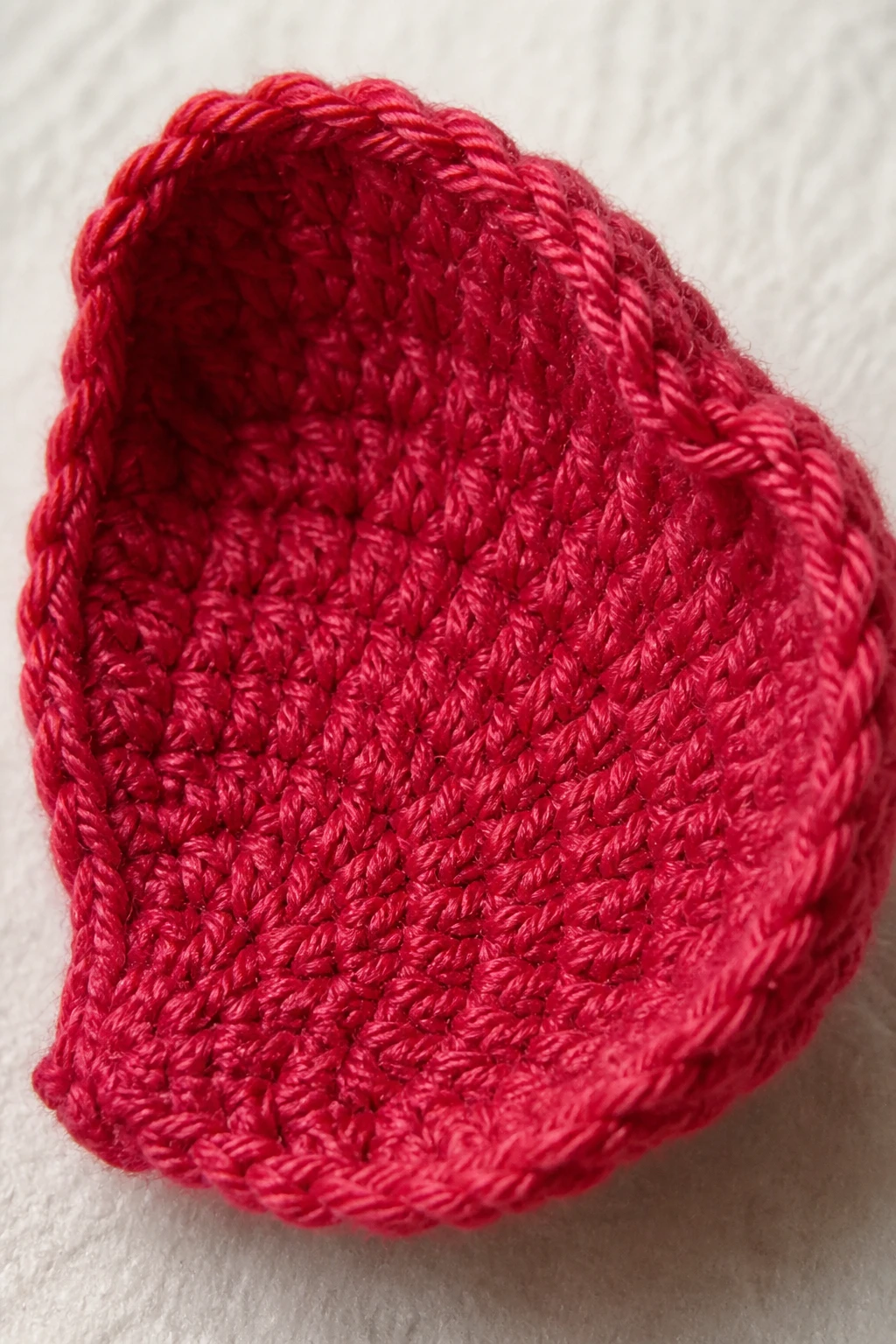 closeup of a single crocheted rose petal with visible stitches