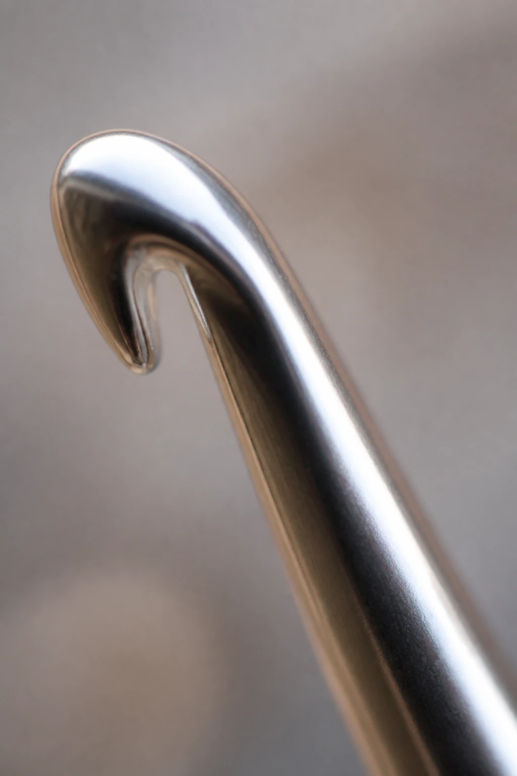 Macro shot of smooth metal crochet hook tip