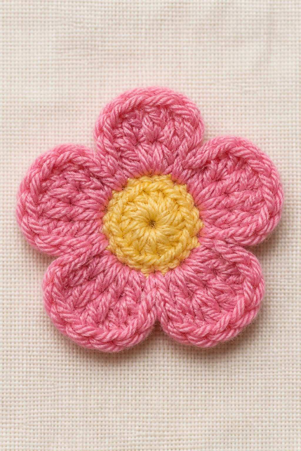 closeup of a single crochet flower applique on fabric