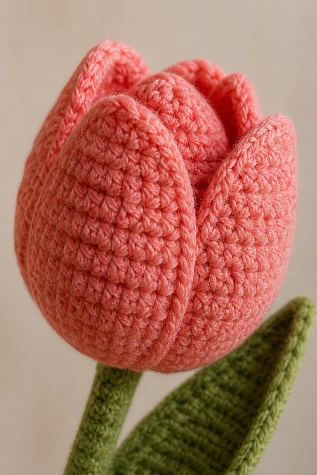 Closeup of a single crocheted tulip bloom with textured wool blend yarn