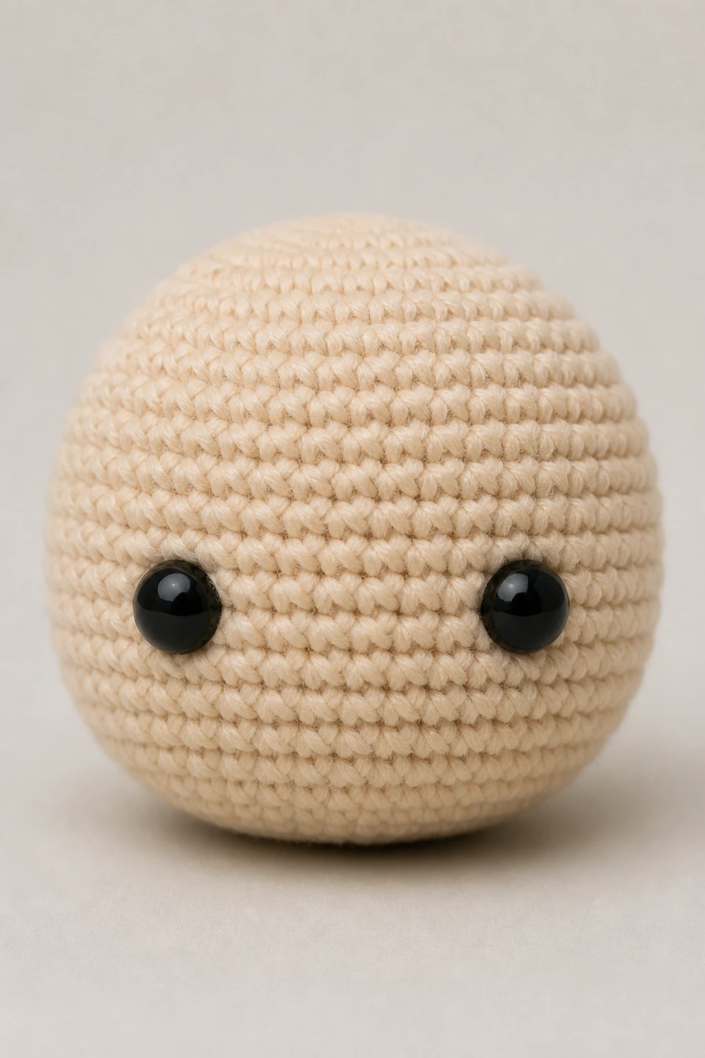 Closeup of a single amigurumi head showing even tension stitches