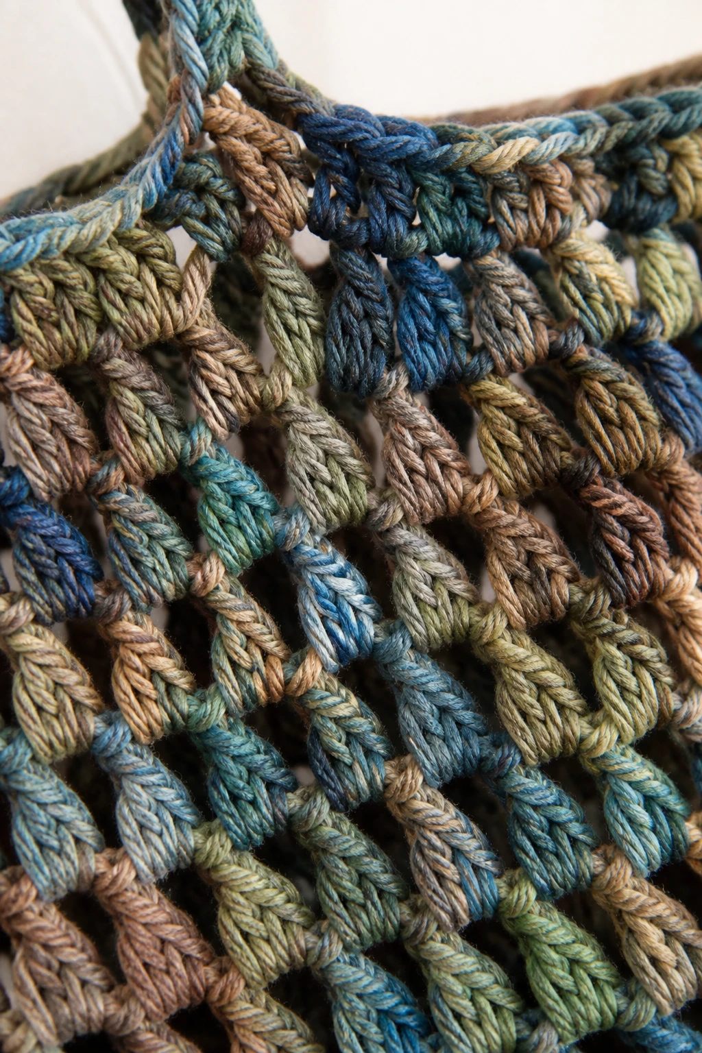 closeup of crochet market bag stitch detail in variegated heavy yarn