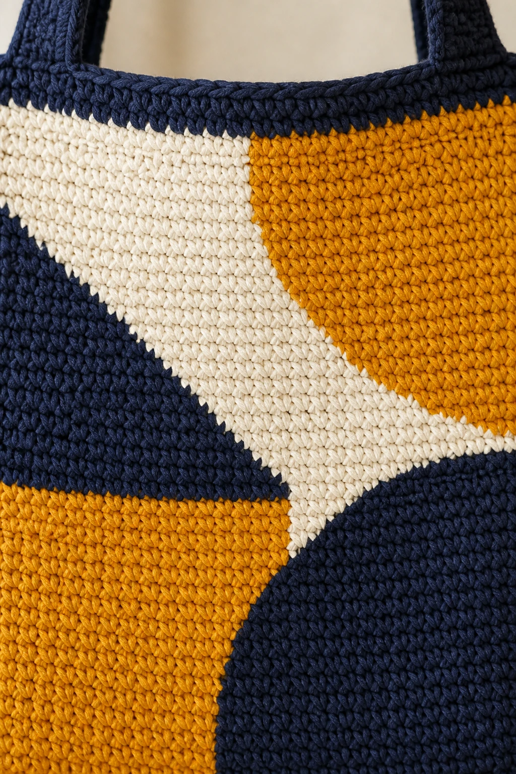Closeup of easy-care yarn stitches forming a bold tote pattern