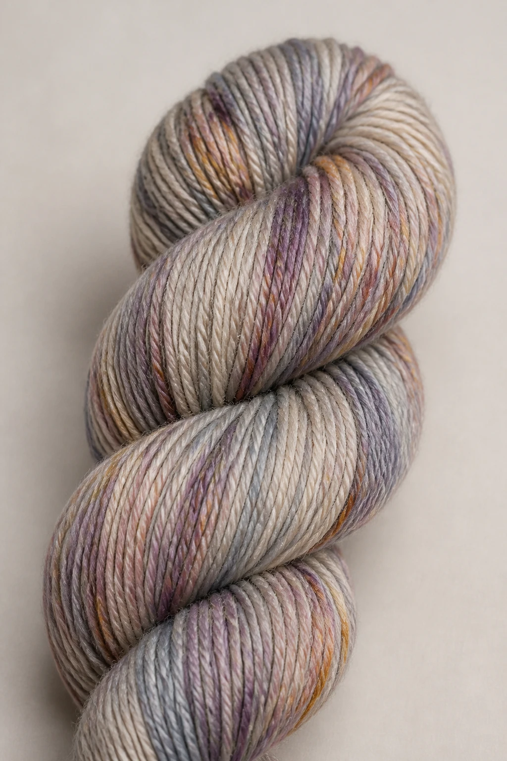Closeup of a single skein with yardage label on a neutral backdrop
