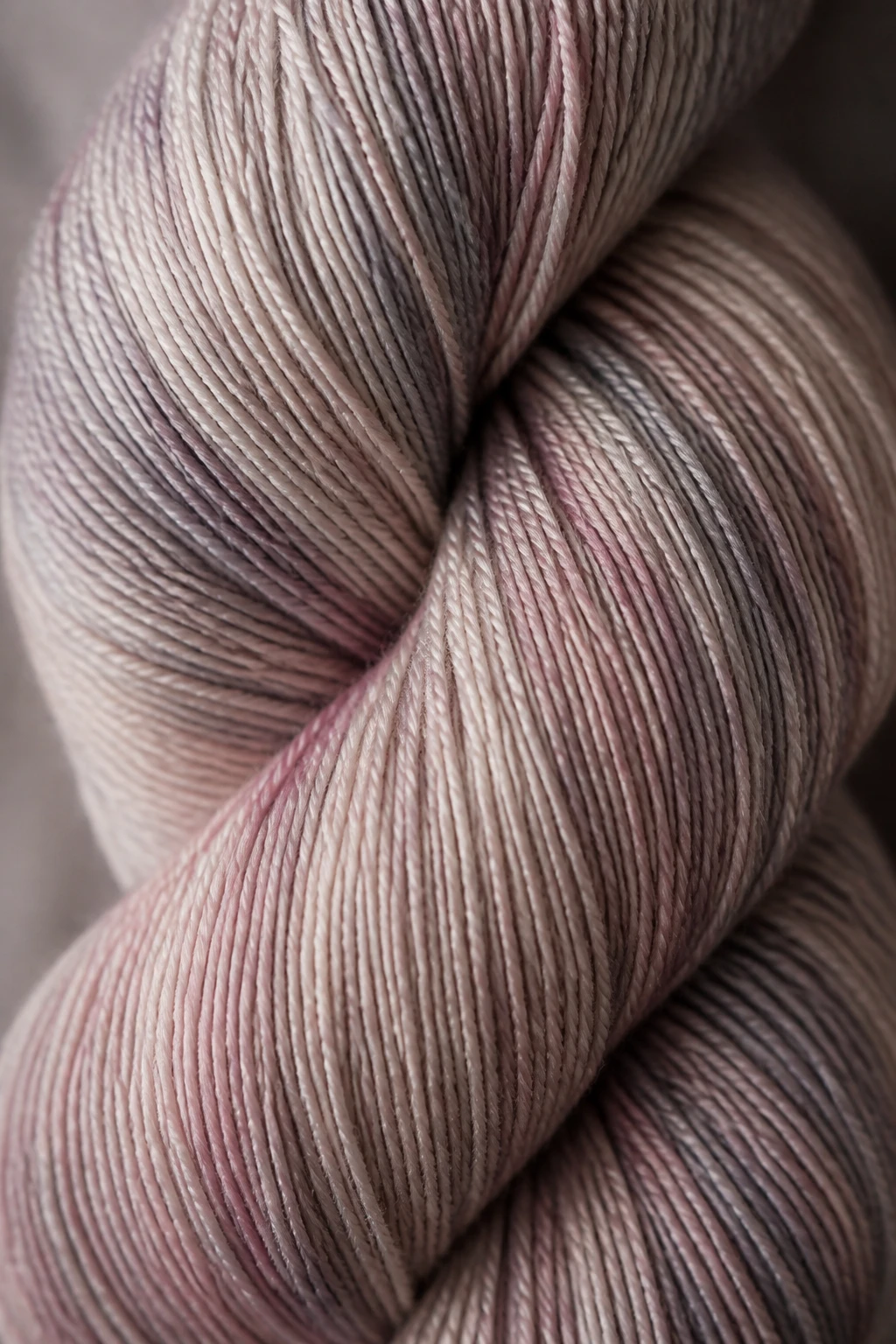 Closeup of lightweight fingering yarn skein, subtle drape emphasis