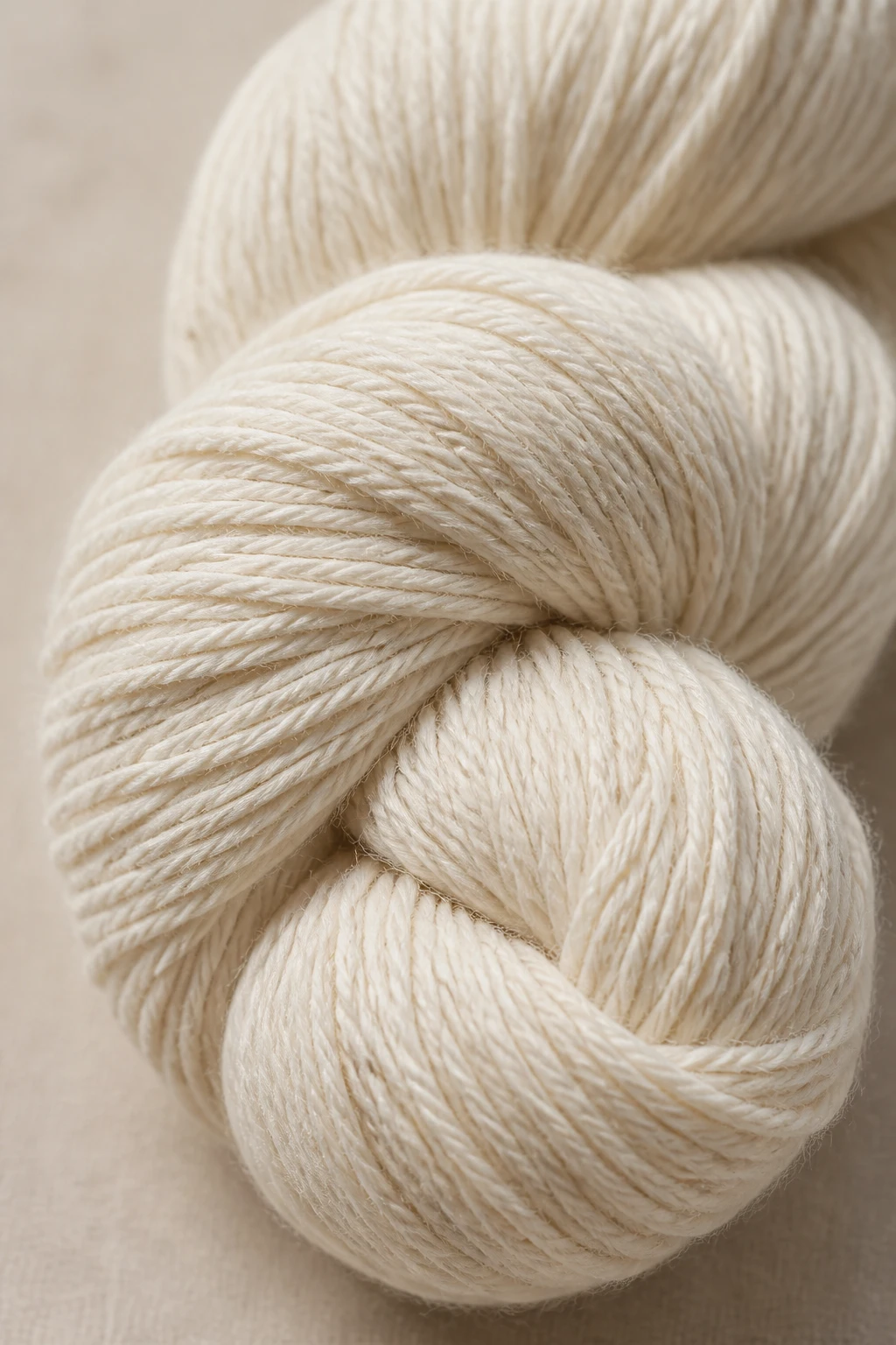 Closeup of a single cotton yarn skein, natural fibers texture emphasized, soft lighting