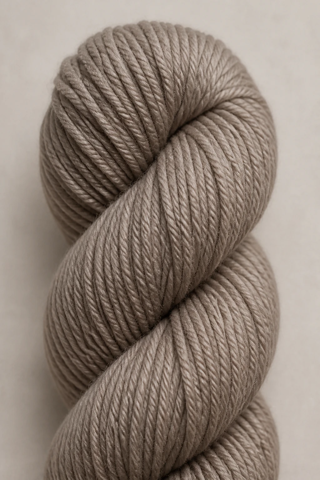 Closeup of a single worsted yarn skein on neutral backdrop