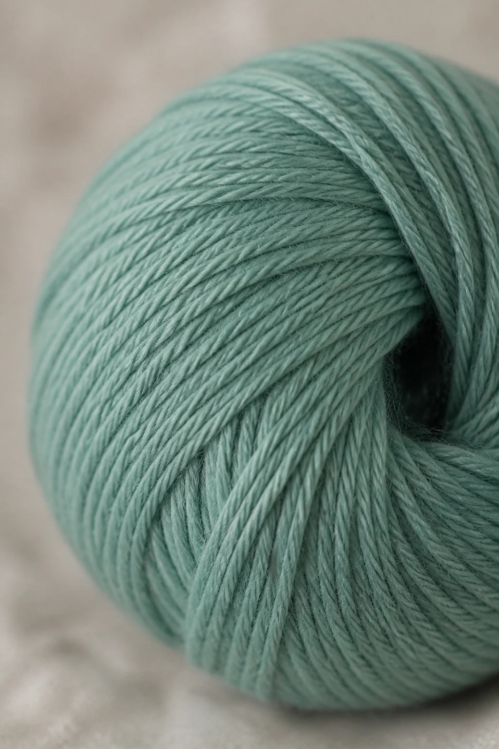 closeup of soft bamboo yarn ball in muted teal with subtle texture