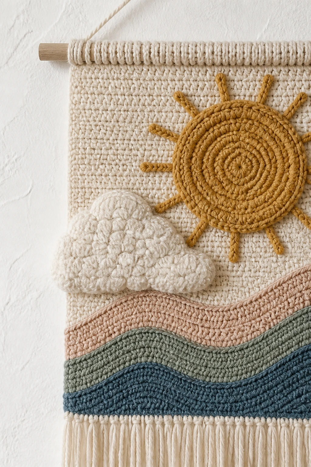 Closeup of a soft crochet wall hanging on a white textured wall