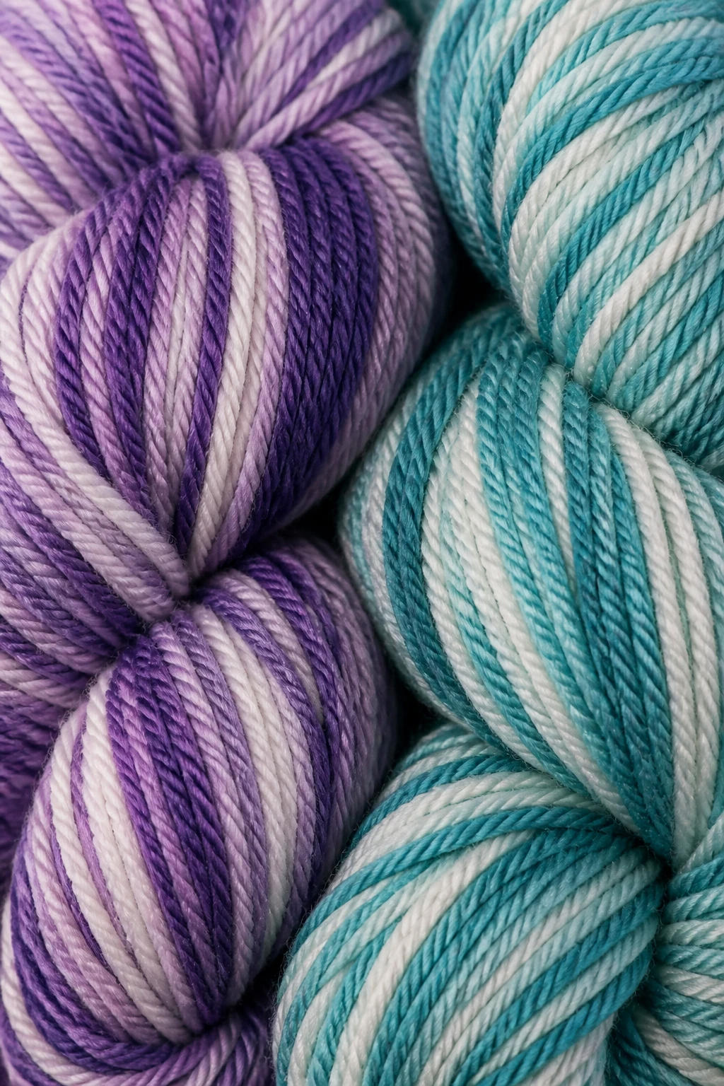 Closeup of two-color mosaic crochet yarn skeins with smooth plied texture